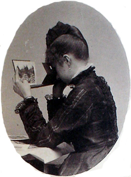 Victorian woman looking into a stereoscopic viewer/book